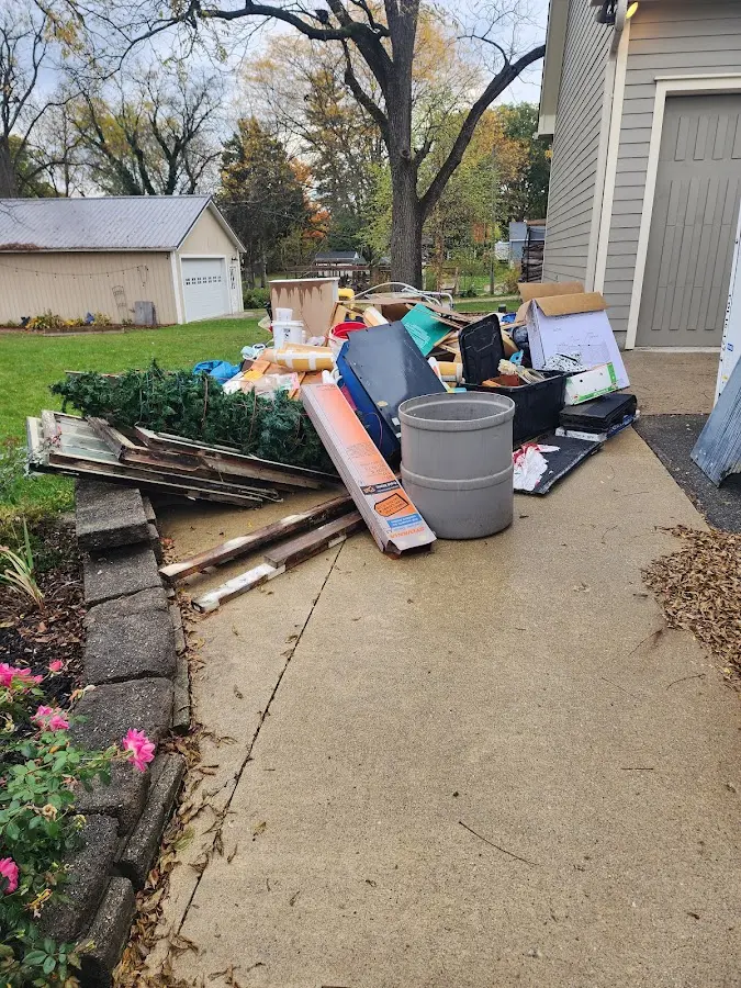 Dumpster being loaded with debris for 10 Yard Dumpster Rental in Highlands